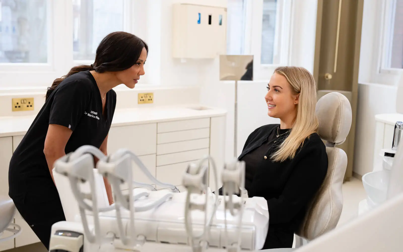 Dr Manrina Rhode welcoming a patient to a consultation at DRMR Clinic, Knightsbridge